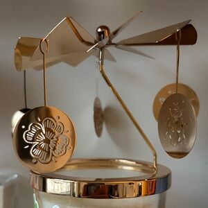 Diptyque Gold Holiday Carousel with five lucky charm tassels for Classic Candle